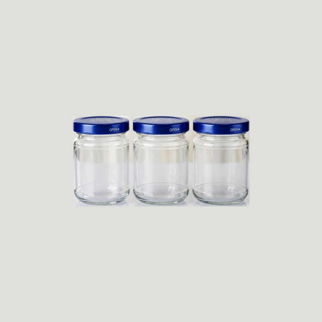 Три чистые пустые стеклянные банки Euro-jar с широким горлышком и синими металлическими крышками.